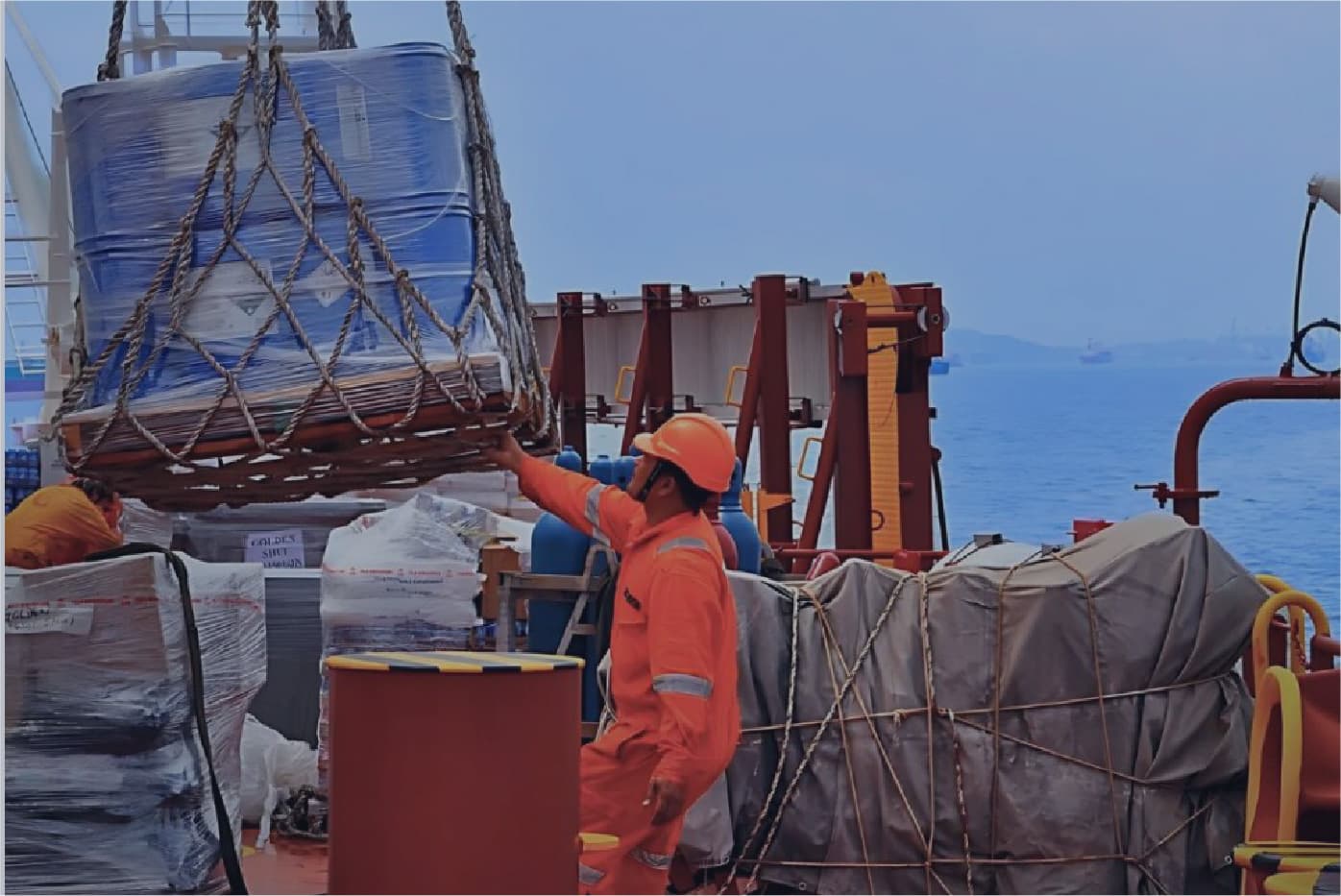 Worker loading supplies onto a vessel at Walvis Bay harbour